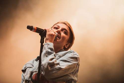 person woman holding black microphone people