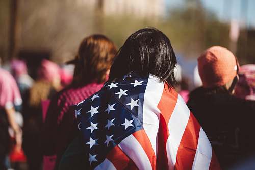 person woman with US American flag on her shoulders people