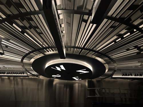 staircase grayscale photo of compass light fixture