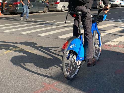 wheel man riding blue bicycle asphalt