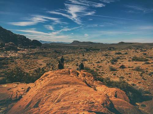outdoors three men standing on rock formation nature