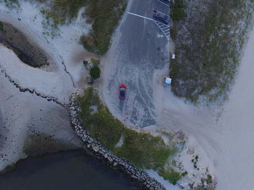 outdoors aerial photo of red vehicle on road scenery