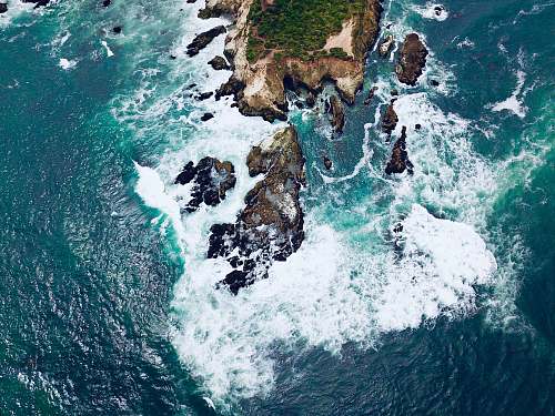 outdoors aerial photography of island surrounded with body of water ocean