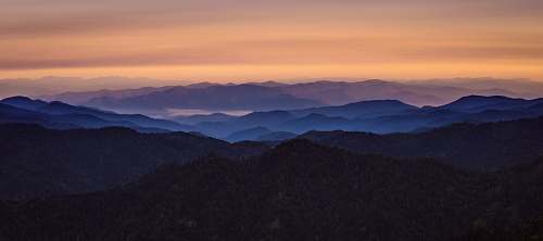 sunrise aerial view of overlooking mountains sunset