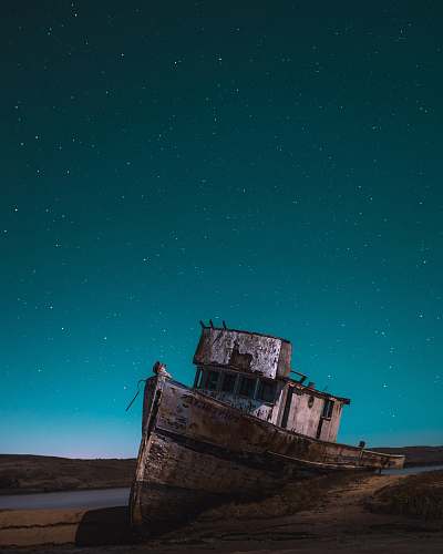 ship brown shipwrecked on shore sky