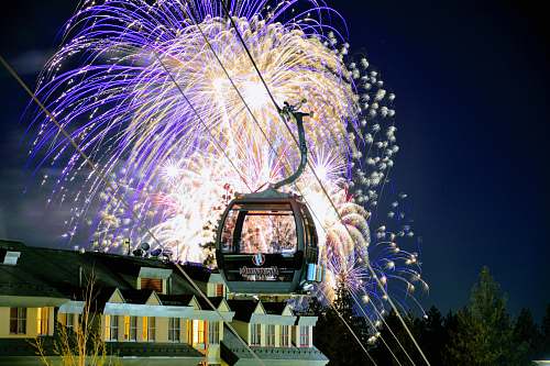 outdoors long exposure photography of cable car under white and blue fireworks night