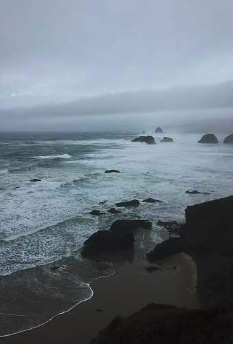 promontory seawaves during daytime water