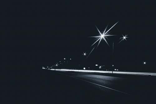 fireworks grayscale photography of time-laps of road outdoors