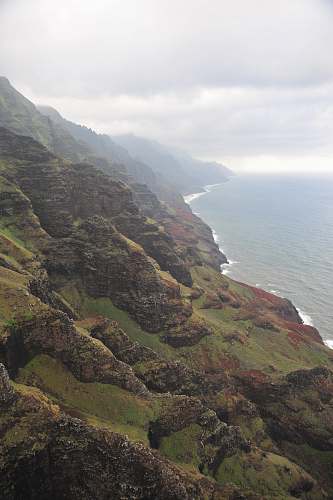 cliff birds eye view of forest covered mountains kauai