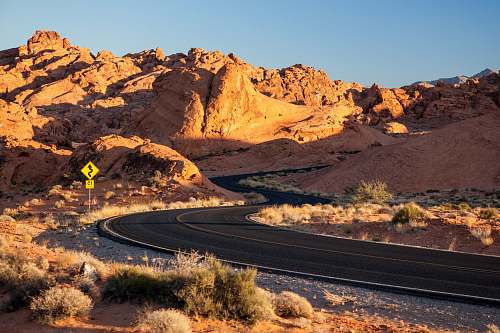 nature landscape photography of whining road near mountains soil