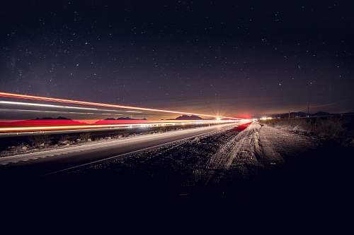nature time-lapse photography of vehicles on road at night road