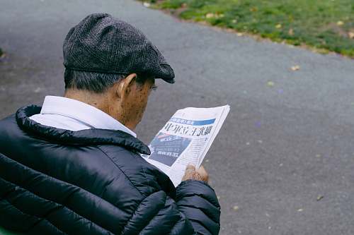 person man reading newspaper human