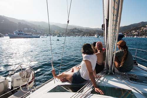 human people sitting on front of yacht boat