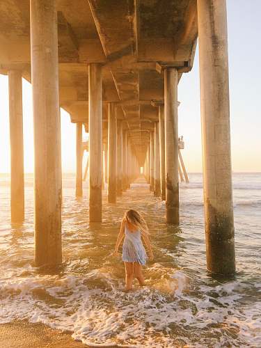 pier woman walking under dock dock