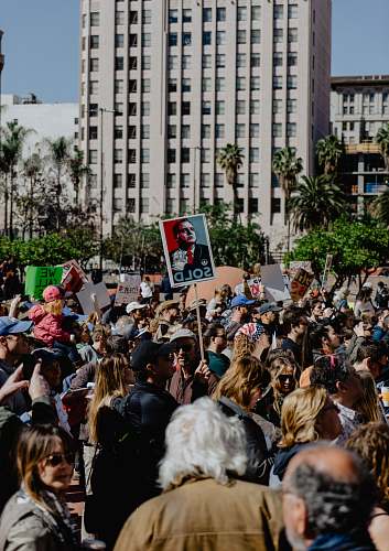 crowd group of person standing near city buildings flora