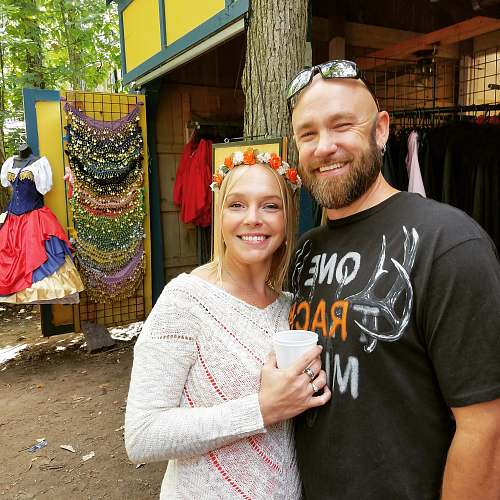 apparel man and woman standing near trees and apparels clothing