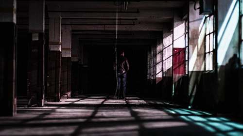human man standing in building corridor