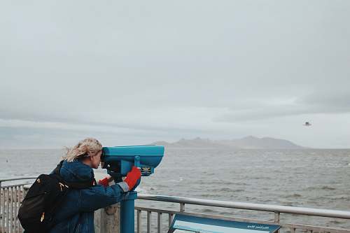 people woman looking thru telescope human