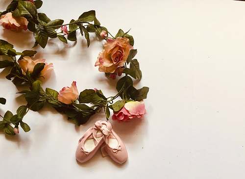 blossom pair of pink ballerina flats ceramic figurine besides flower wreathes flower