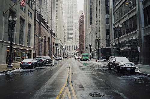 grey parked vehicles beside road and building at daytime street