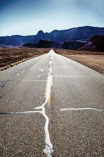 asphalt road towards rocks tarmac