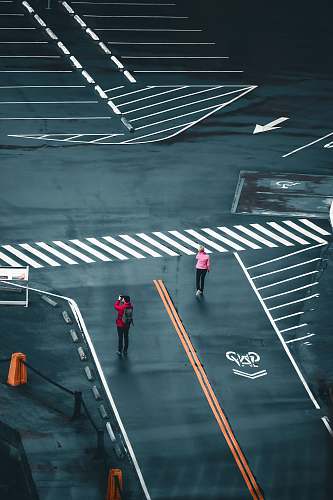 asphalt two people standing on road in aerial photo tarmac
