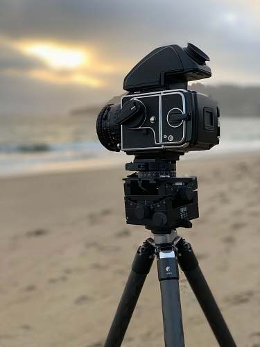 robot selective focus photography of black DSLR camera with tripod sand ladder