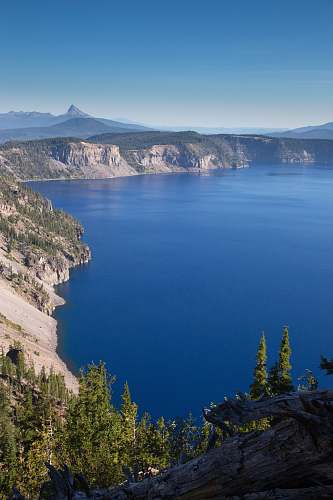 lake landscape photo of mountain near body of water tree