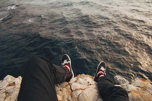 shoe man sitting on cliff davenport