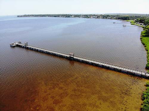 waterfront white and gray beach dock near sea dock