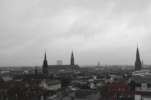 building aerial view of city under gray sky spire
