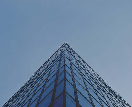 blue architectural photography of blue glass building building
