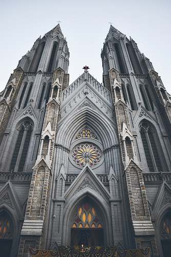 building bottom view of cathedral under white sky spire