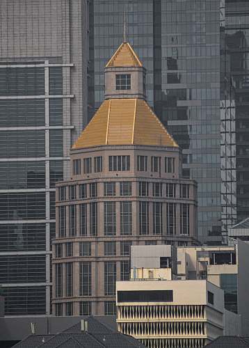 building brown and gold cement tower spire