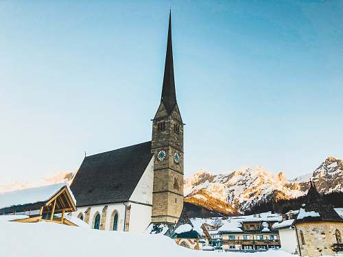 building brown and white concrete house near mountains spire
