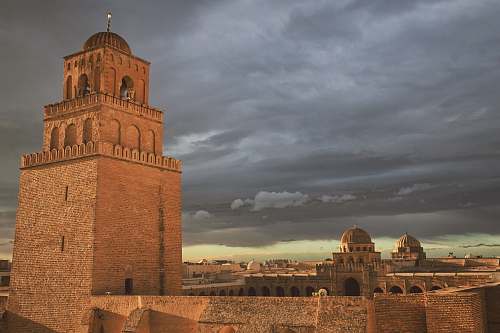 building brown castle under gray skies dome