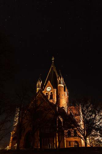 building brown cathedral during nighttime tower