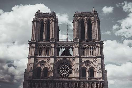 cathedral brown concrete building under white clouds paris