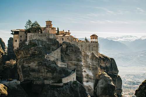 building city on top of rock formation during daytime housing