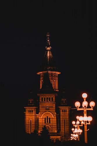 building concrete building at night spire