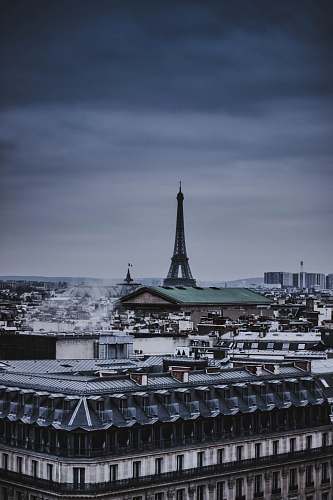 building Eiffel Tower in middle of small buildings spire