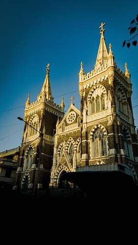building gray church during daytime spire