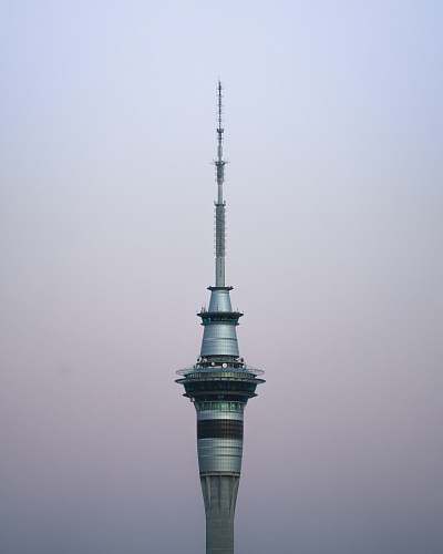 building gray concrete building under clear blue sky spire