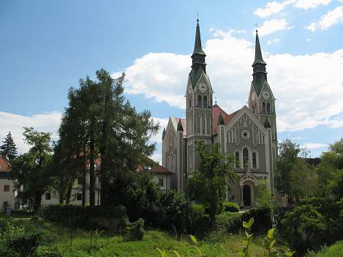 building gray Gothic cathedral under cumulus clouds spire