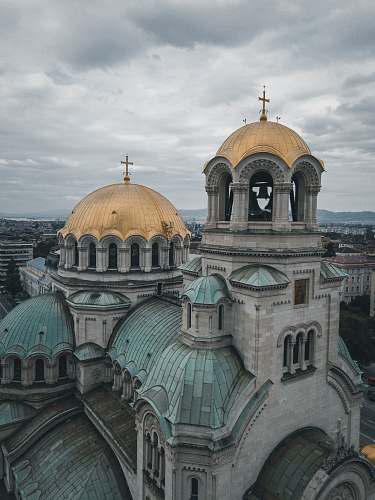 building gray stone church with domed roofs dome