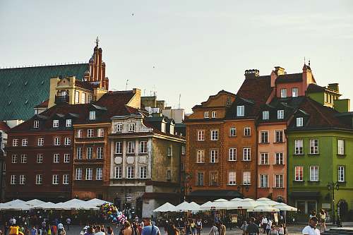 poland group of people on street near the brown concrete building city