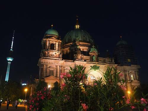 building lighted white and teal concrete dome at night time dome