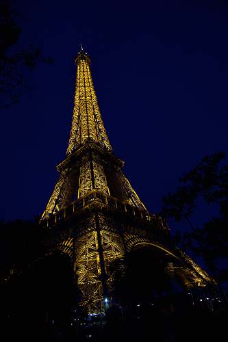 building low angle photo of Eiffel Tower at night spire