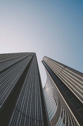 building low angle photo of gray concrete high-rise building city