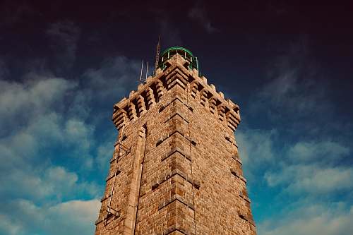 building low-angle photography of brown building tower